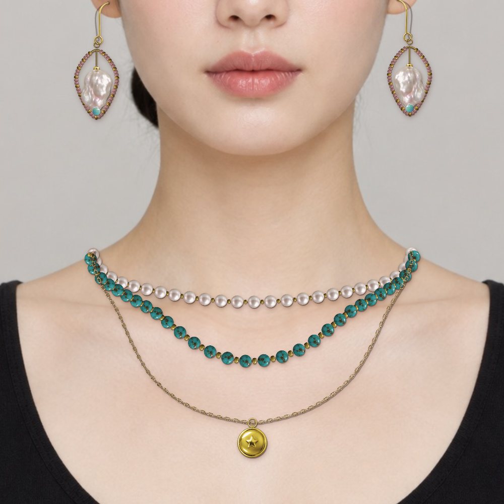 Three necklaces layered at 40, 45 and 50 cm with matching hoop earrings, on a model