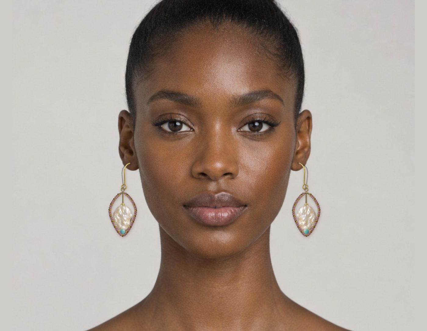Beaded hoop earrings with baroque pearls shown on a model