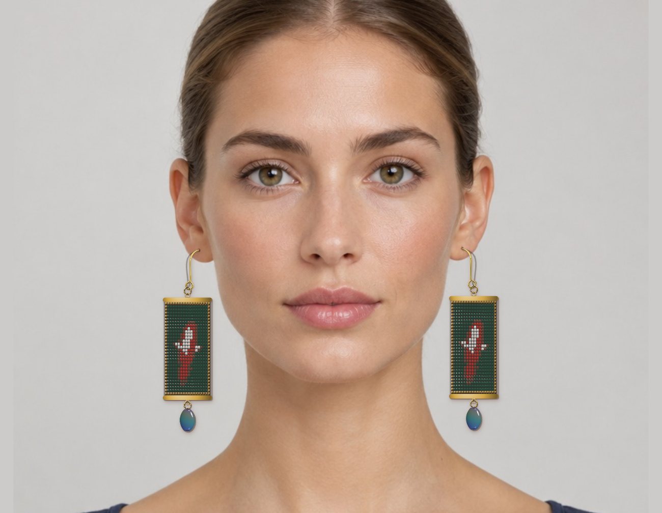 Loom-woven koi fish earrings shown on a model